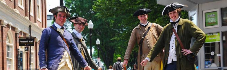 Four tour guides in colonial-times costumes in the Freedom Trail
