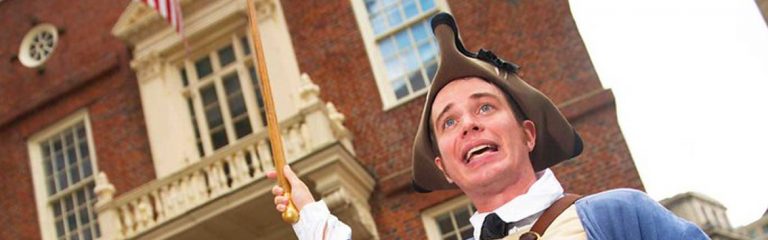 Tour guide dressed in colonial-times costume walking the Freedom Trail