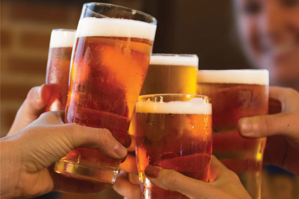 various hands holding five glasses full of beer for things to do in Boston this winter