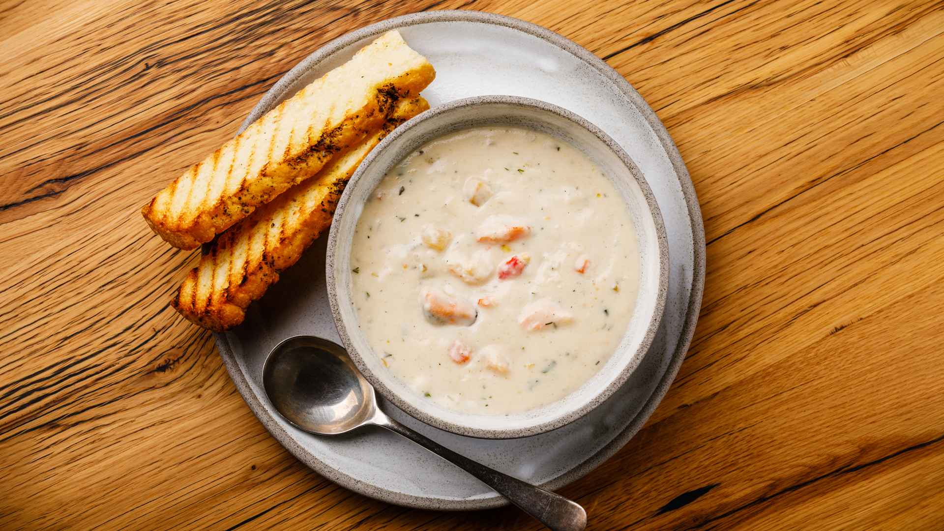 photo of a bowl of clam chowder with toast on the side at a historic boston restaurant